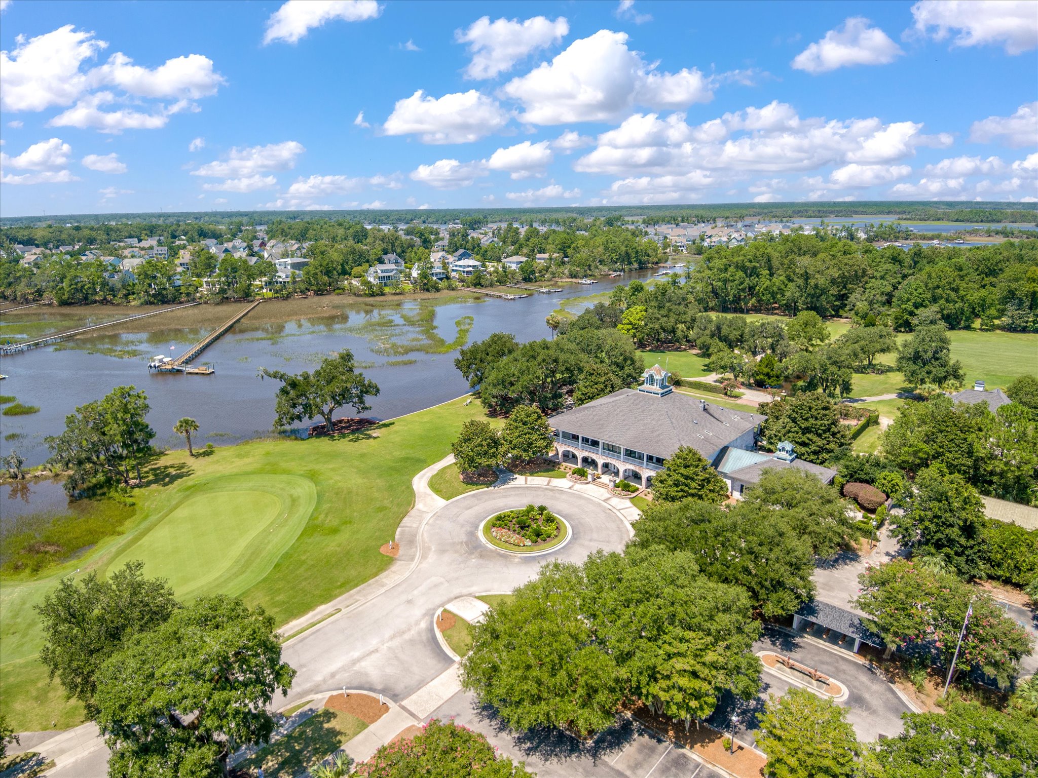 Aerial view of Dunes West in Mount Pleasant, South Carolina, overlooking Wagener Creek with waterfront homes, private docks, mature trees, and Lowcountry marshlands leading to the Wando River.