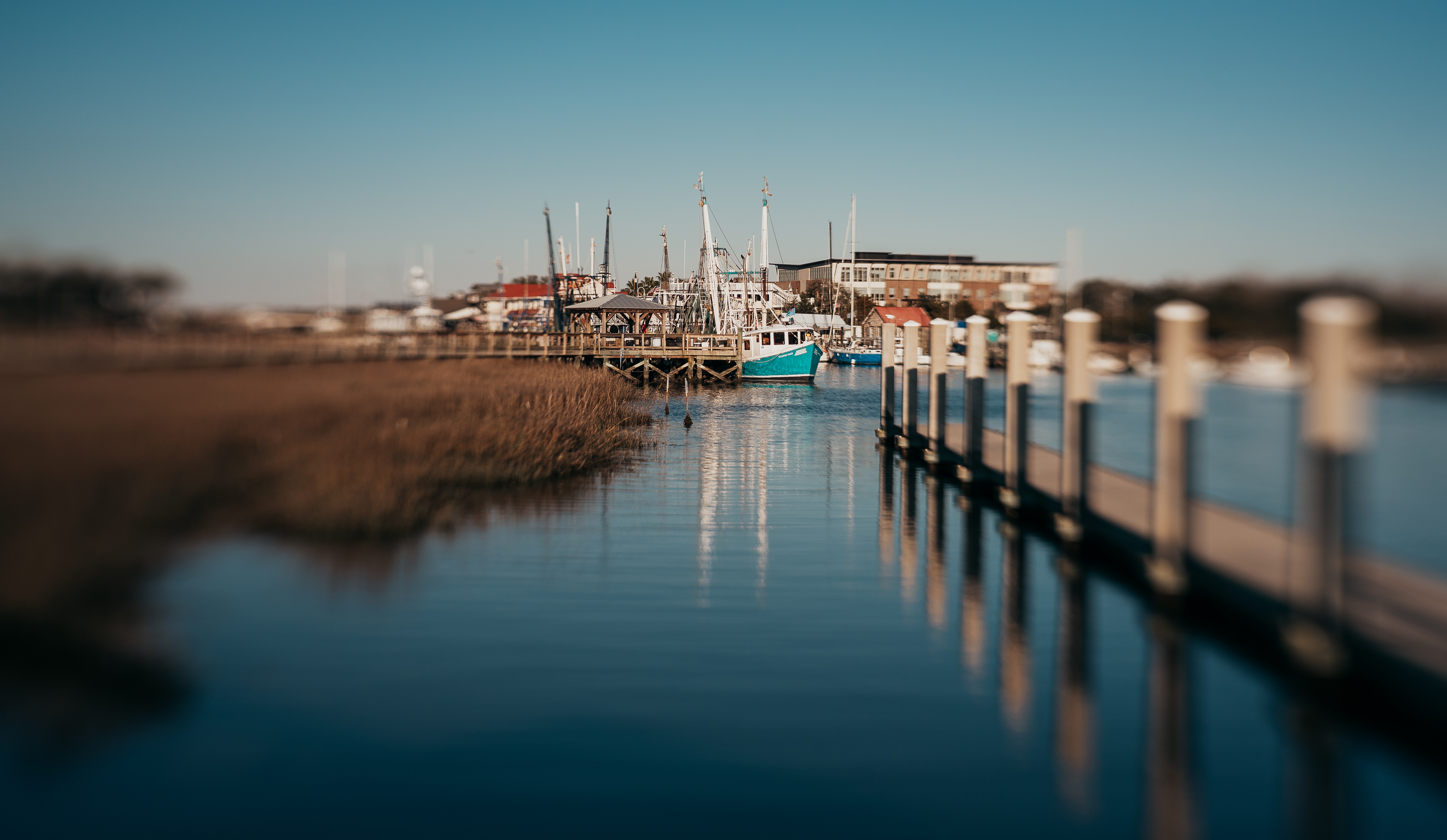 Private docks along Shem Creek in the Old Village of Mount Pleasant, South Carolina, showcasing waterfront homes, tidal marshes, shrimp boats, and Lowcountry coastal living.